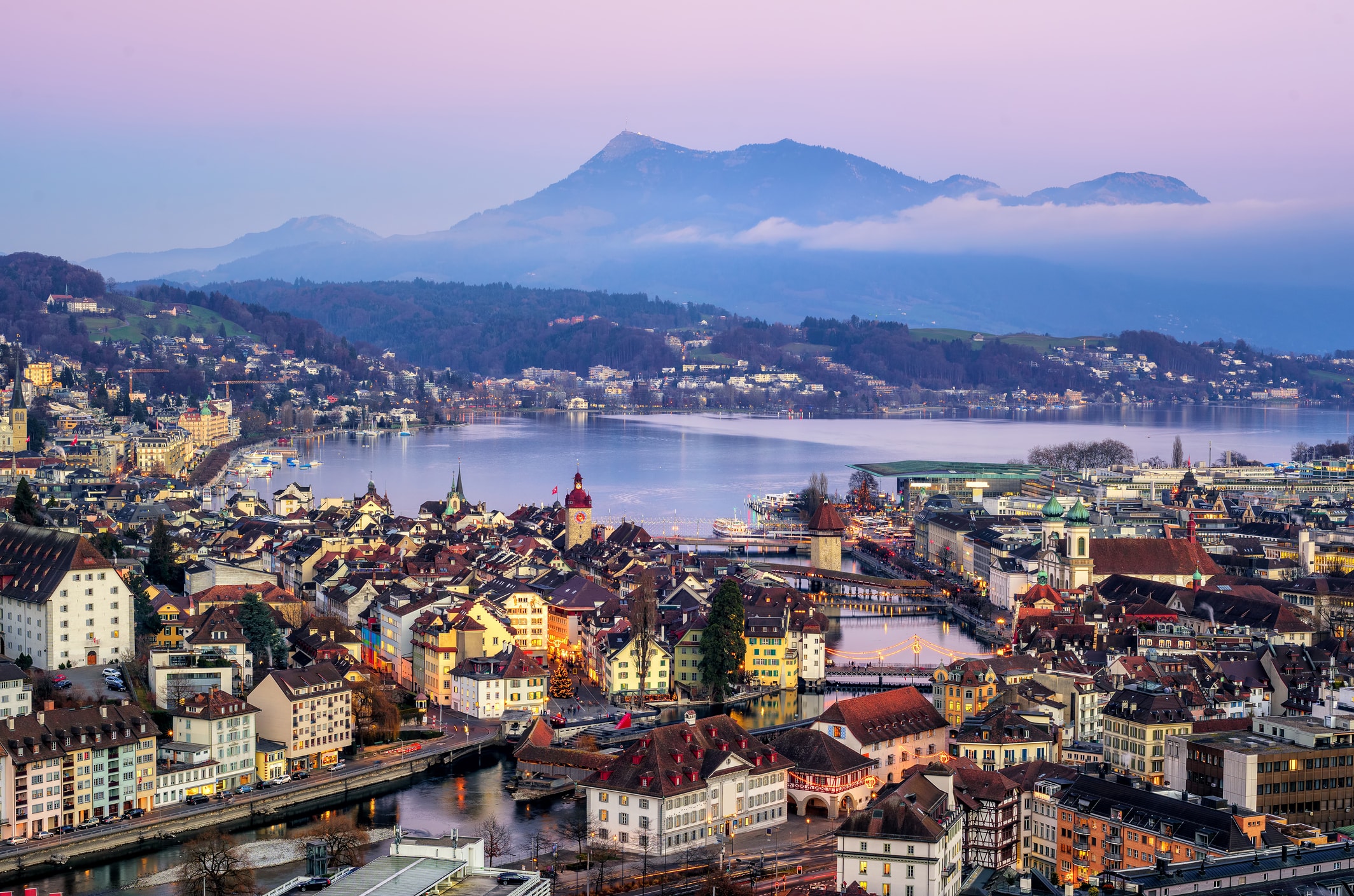 Visit Riji also called The Queen of Mountains from Lucerne by cogwheel railway from Vitznau. The city of Lucerne in the evening with Mount Rigi in the background.