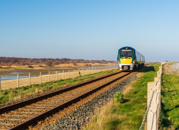 Irish Rail train coasting through a sunny day