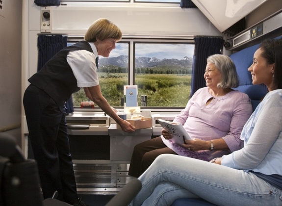 friends relaxing and being catered to in Amtrak's accessible bedroom