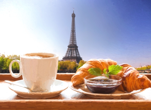 Coffee and croissants against Eiffel Tower in Paris, France