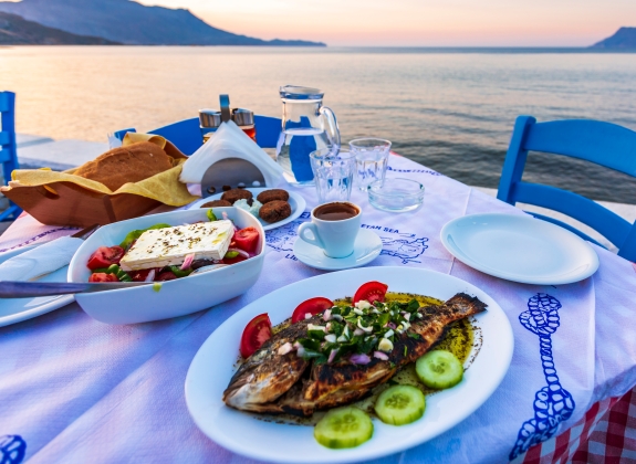 Traditional Cretan Dorada fish with Greek salad in Crete, Greek Islands, Greece, Europe
