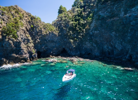 Ischia, lonely boat in a turquoise bay near Lacco Ameno. Naples, Italy