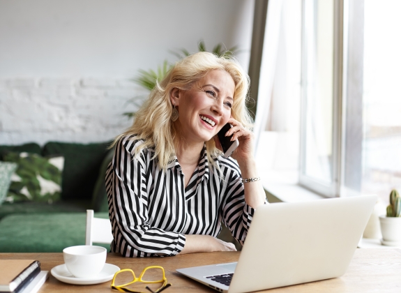 woman sitting at desk in front of open laptop