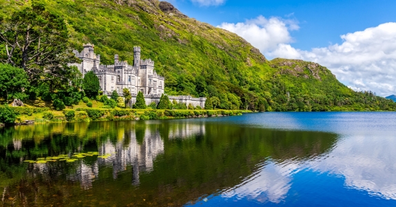 Kylemore Abbey, beautiful castle like abbey reflected in lake at the foot of a mountain. Benedictine monastery founded in 1920, in Connemara, Ireland