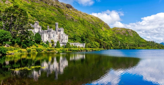 Kylemore Abbey, beautiful castle like abbey reflected in lake at the foot of a mountain. Benedictine monastery founded in 1920, in Connemara, Ireland