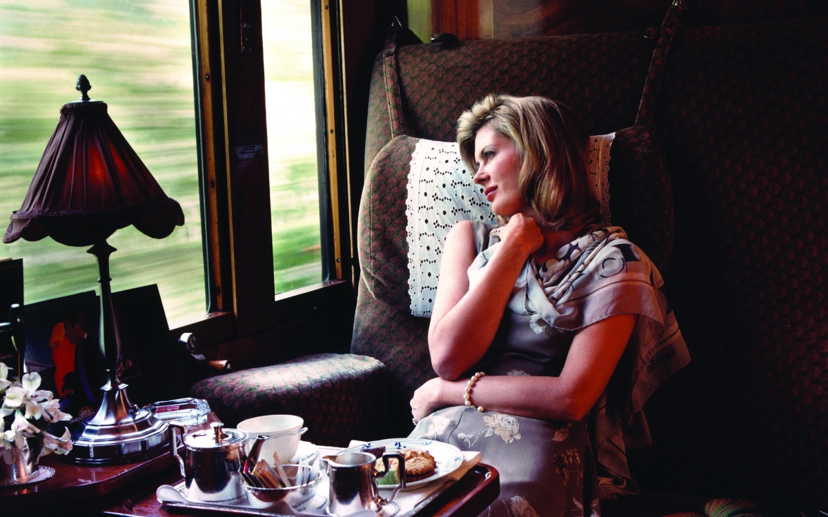 A lady relaxes in comfortable train seat 