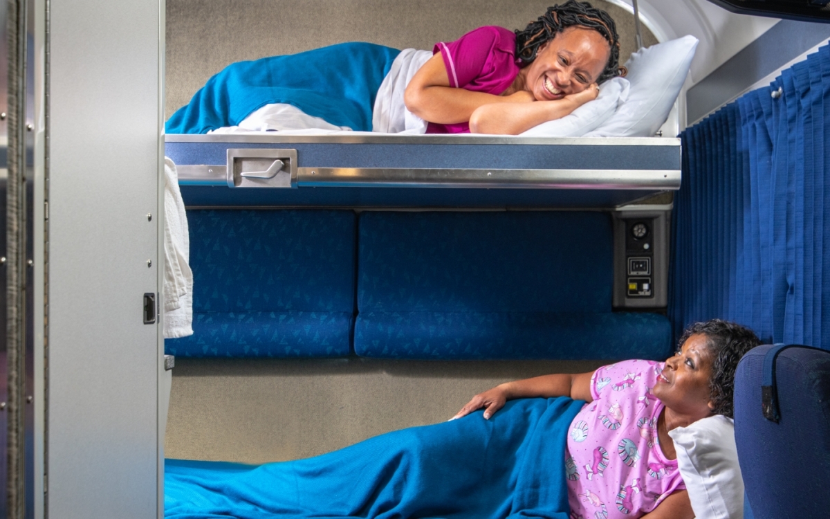 friends relaxing in Amtrak's bedroom suite beds at night