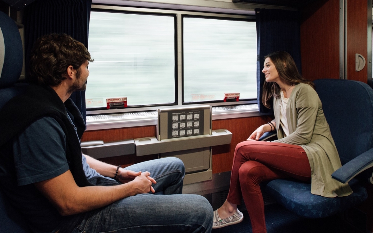 couple relaxing in an amtrak private bedroom