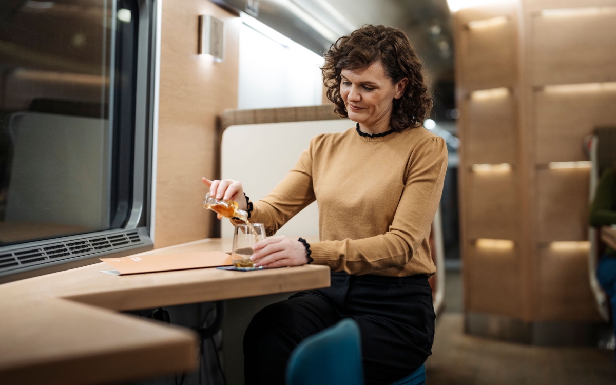 woman dining on the Caledonian Sleeper