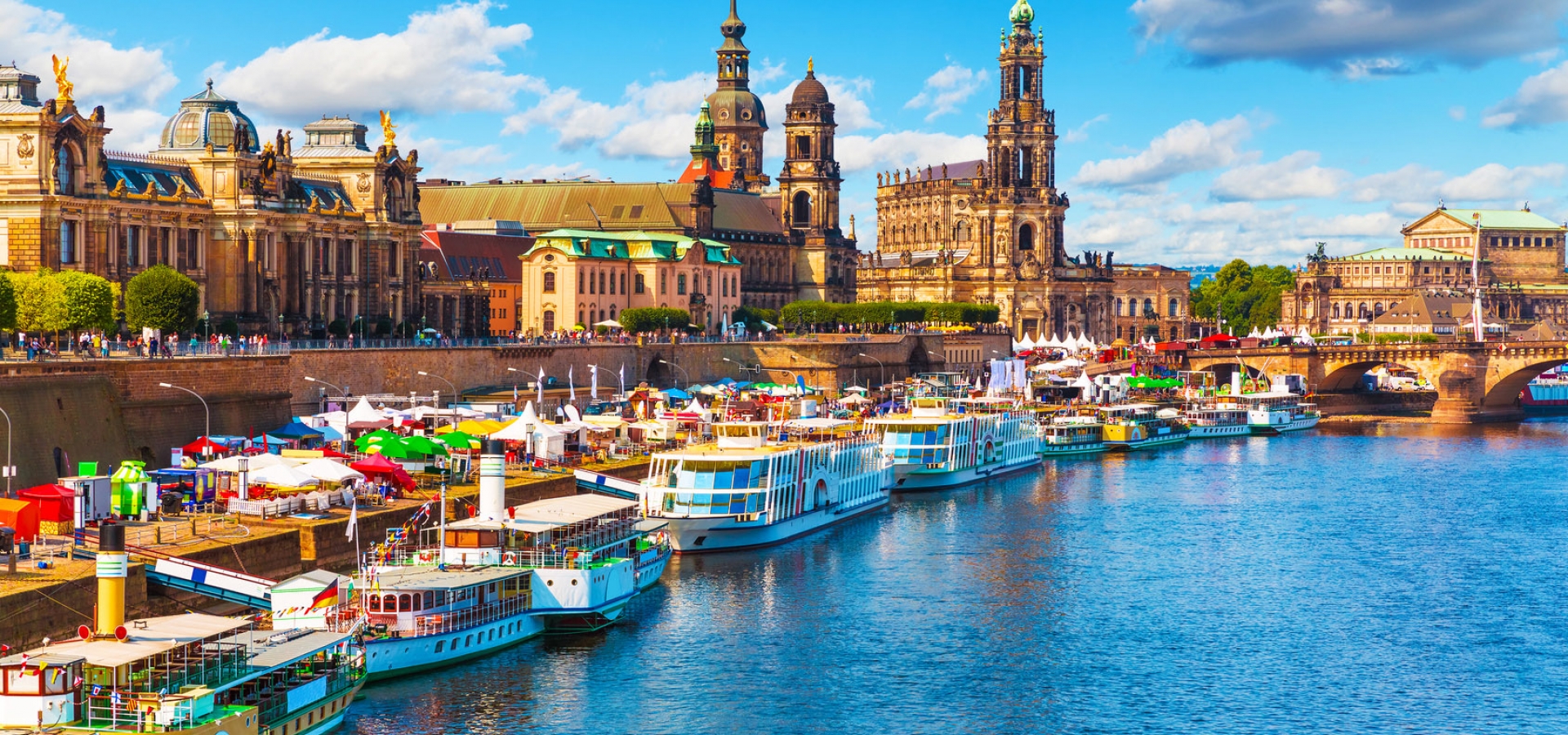 Colourful boats docked in the Elbe river alongside the city of Dresden, Germany.