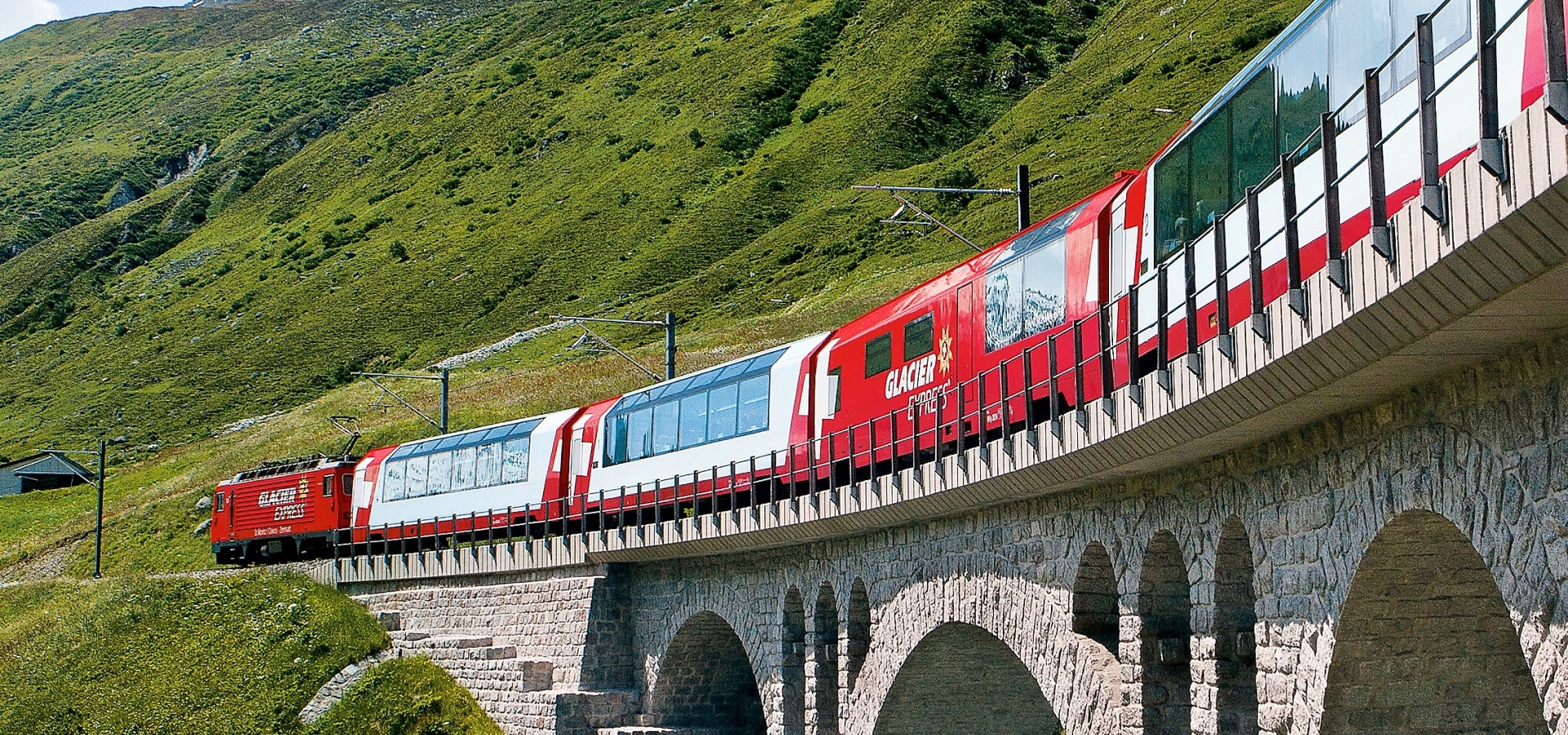 A train travels over a small river in Switzerland