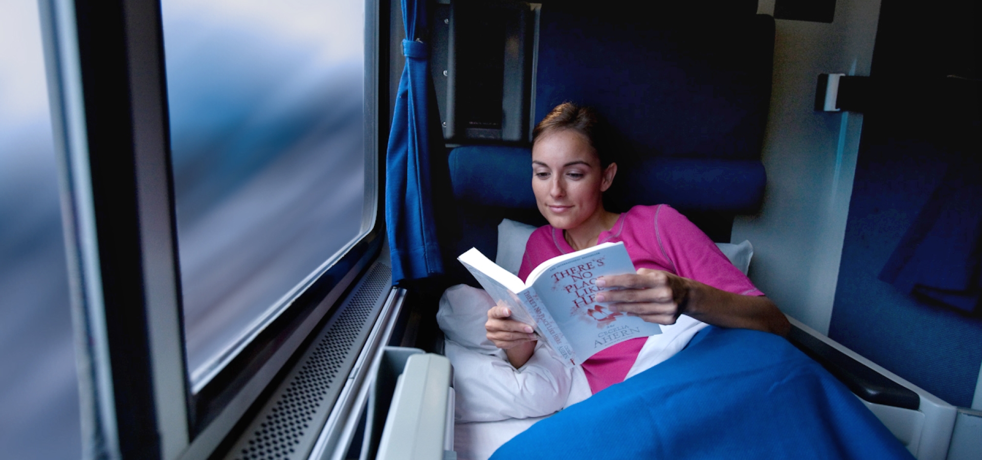 woman reading onboard Amtrak train in US