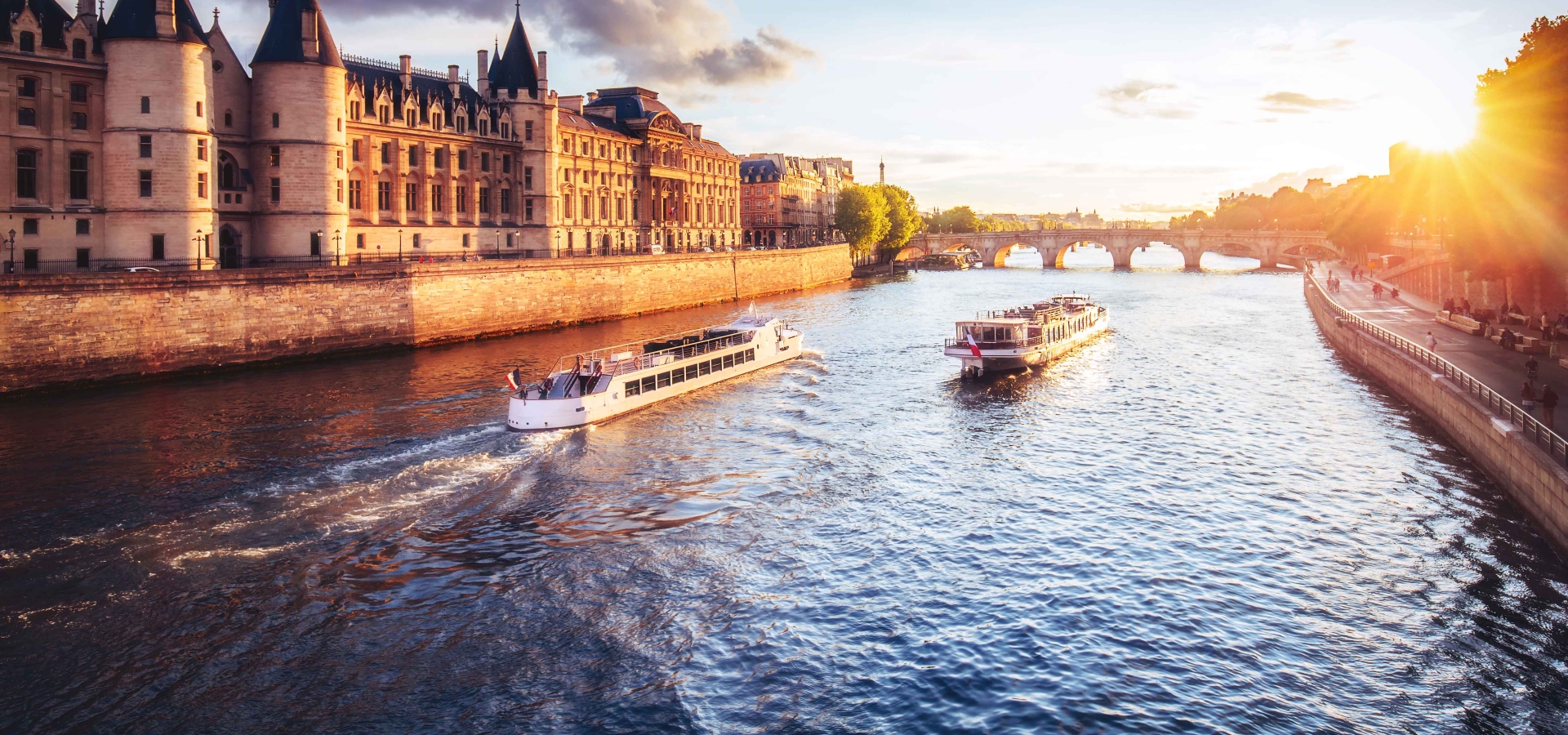 Dramatic sunset over Cite in Paris, France, with Conciergerie, Pont Neuf and river Seine.