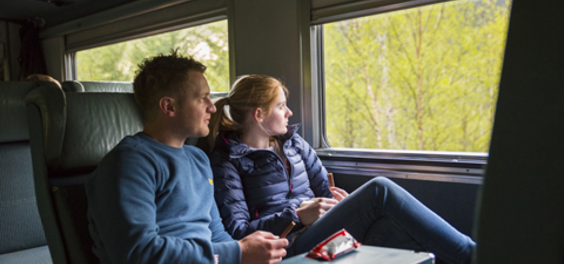 couple looking out window on via rail Economy class
