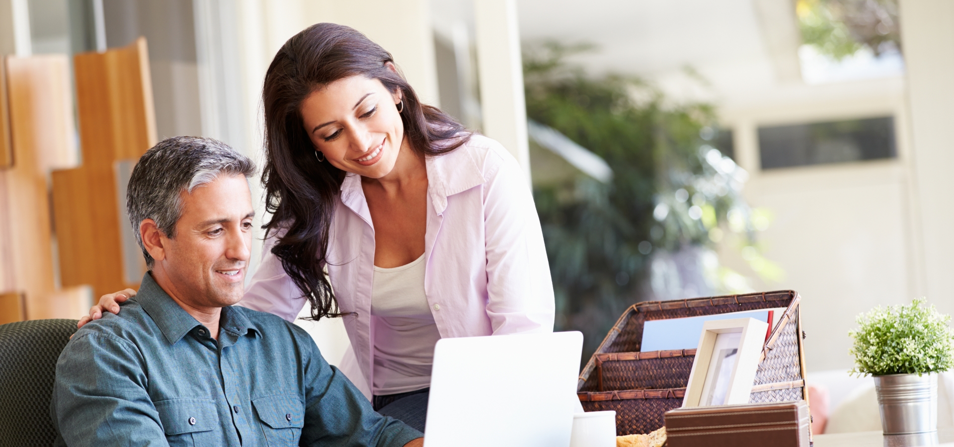 couple looking at a computer while customising their train trip