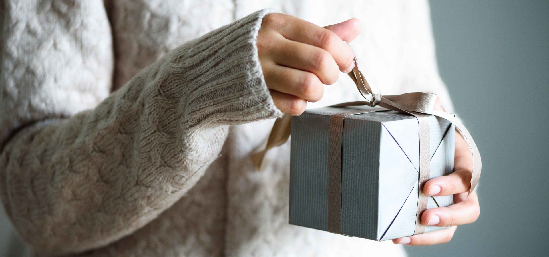 woman's hands opening gift