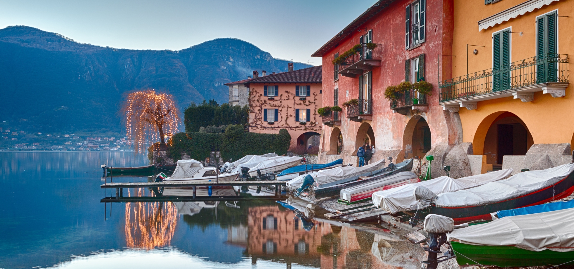 boats on calm waters of lake como, italy