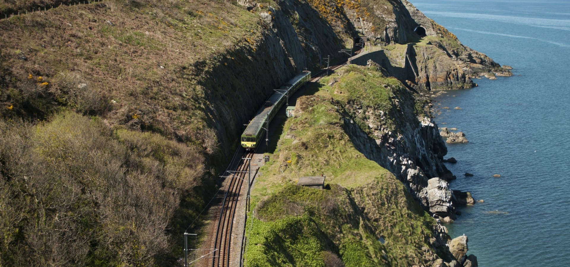A train travels alongside the Irish Coast