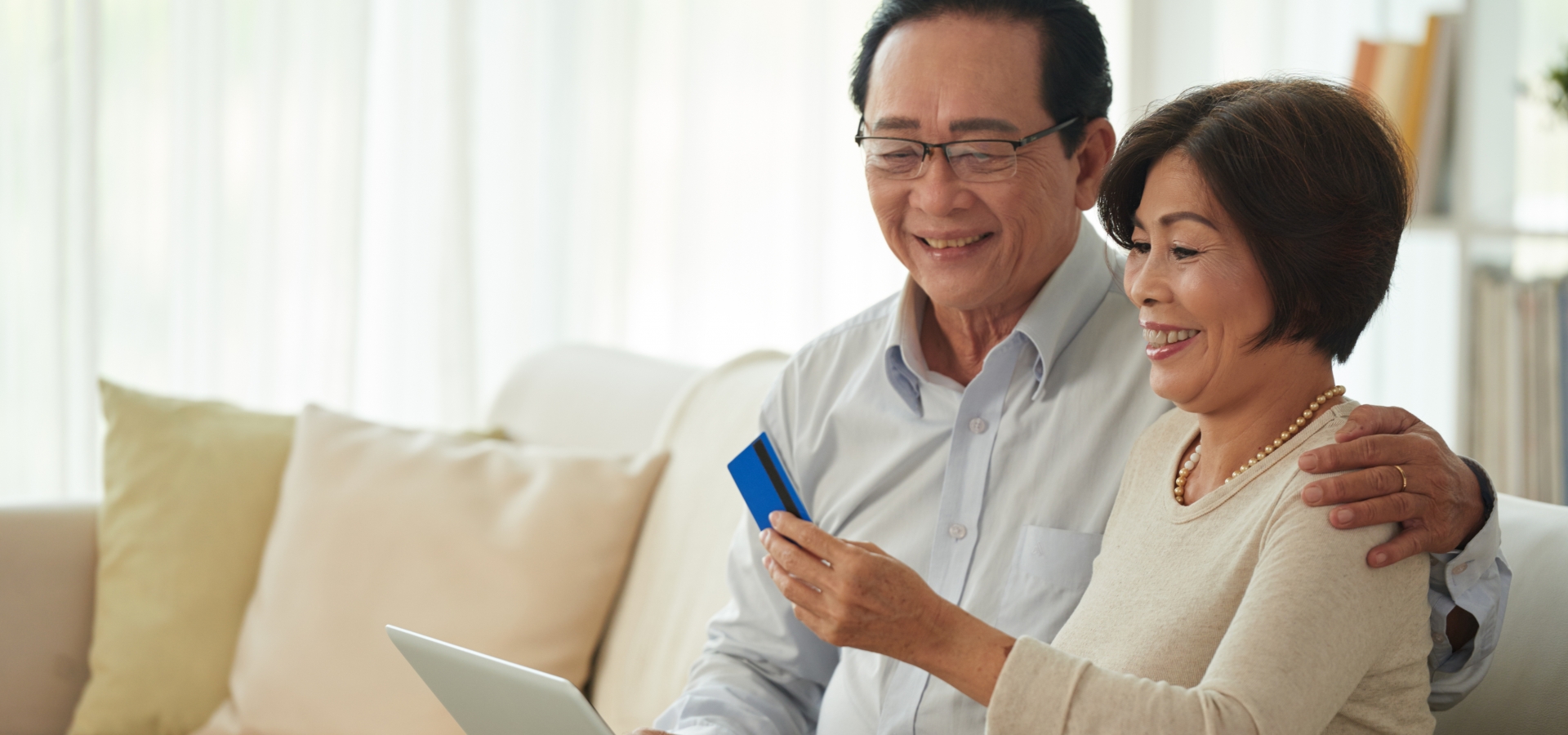 happy couple with credit card for payment options