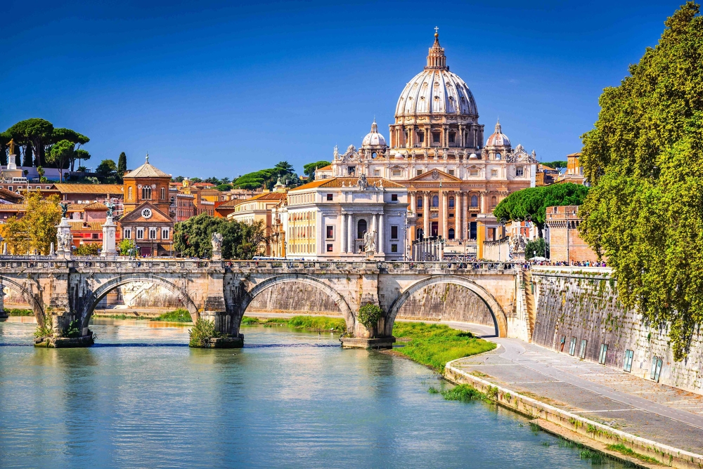 St. Peter's Basilica in Vatican City, as seen across the Tiber River in Rome, Italy