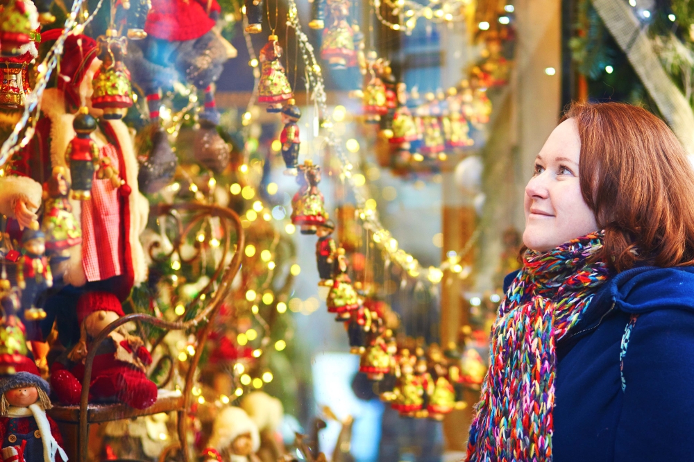 woman window-shopping-at a Christmas-market